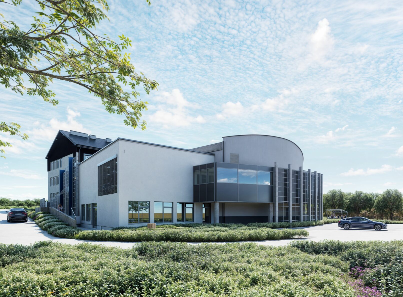 Exterior rendering of a modern institutional building with a curved glass facade on the right and a more traditional section with a dark roof on the left. The building is surrounded by green landscaping and a paved driveway with cars, under a cloudy sky.