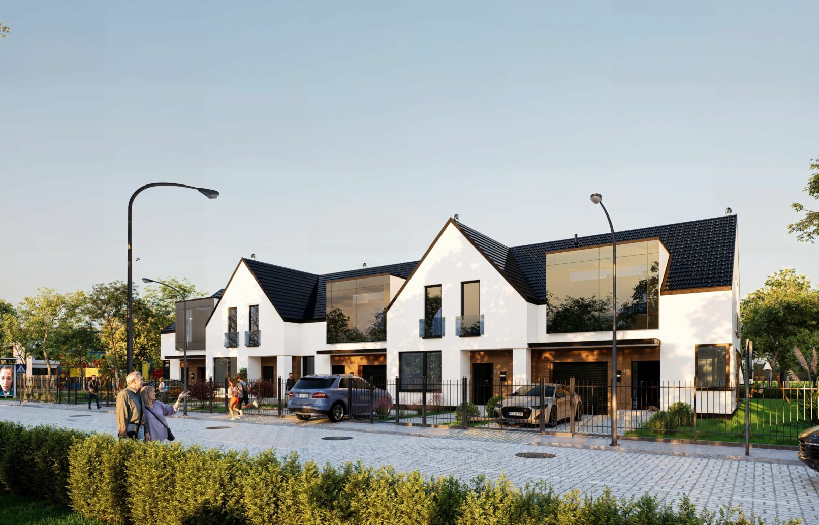 A modern suburban housing development featuring white gable-roofed buildings with dark accents, large windows, and fenced front gardens. The visuals capture different angles of the row houses set against a soft blue sky and cobblestone street with people walking, cars parked, and lush greenery enhancing the residential atmosphere.