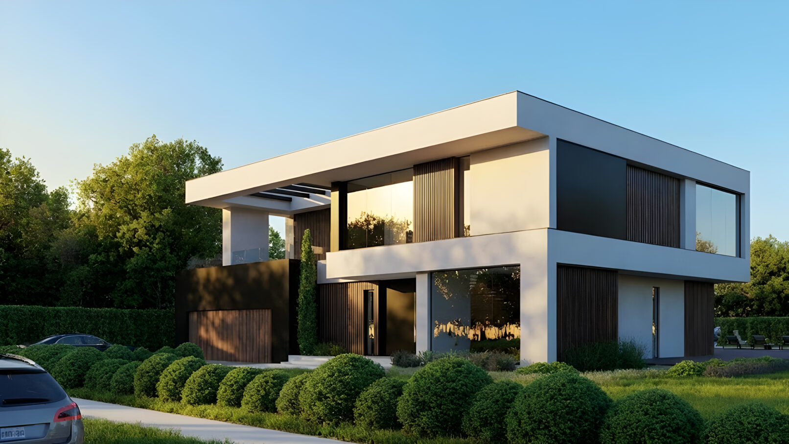 Angled street view of a modern residence with expansive windows, black cladding, and natural wood elements. The house is surrounded by lush landscaping and clear blue sky